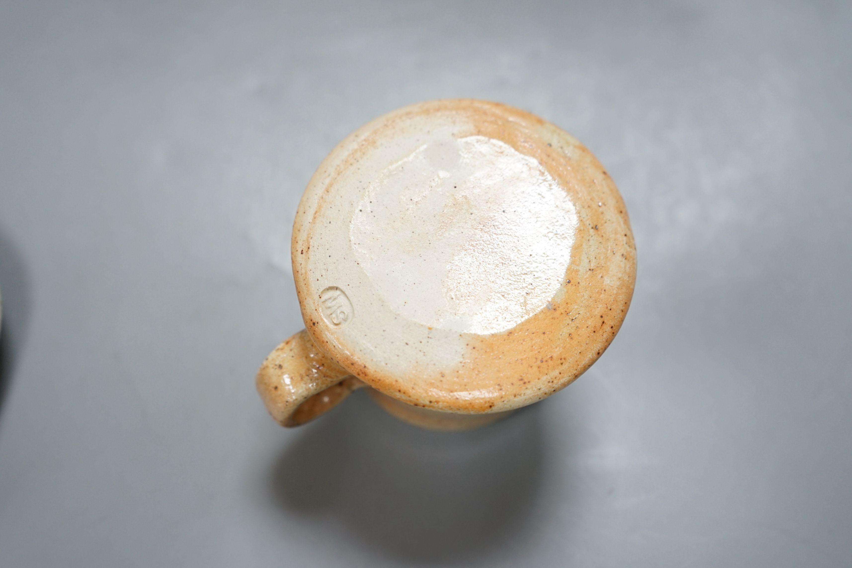 Sarah Walton (b.1945), a salt glazed stoneware flower brick, together with a salt glazed butter dish and cover, a similar mug, and a ‘Field’ horizontally carved linear slab, 22cm wide, all with impressed marks, (4)